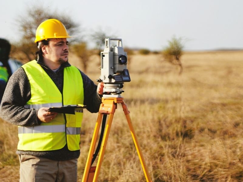 Alta survey property measurements | Sacramento Land Surveying Surveyor conducting an ALTA survey to document property features and boundaries